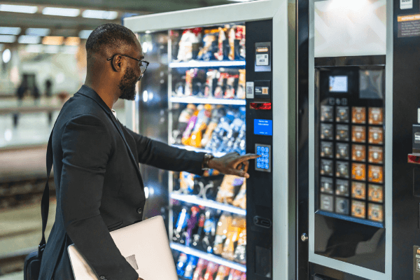 A man in a suit at a vending machine