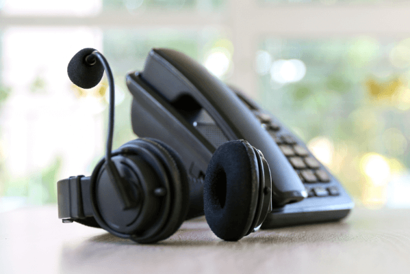 A black office phone with headset